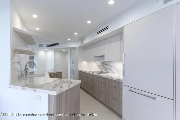 a view of an empty room with a kitchen