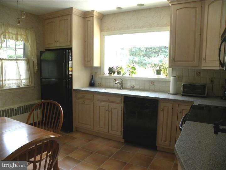 319 Southcroft Road Springfield, PA 19064 - Photo 7 of 24 a kitchen with a sink a window and stainless steel appliances