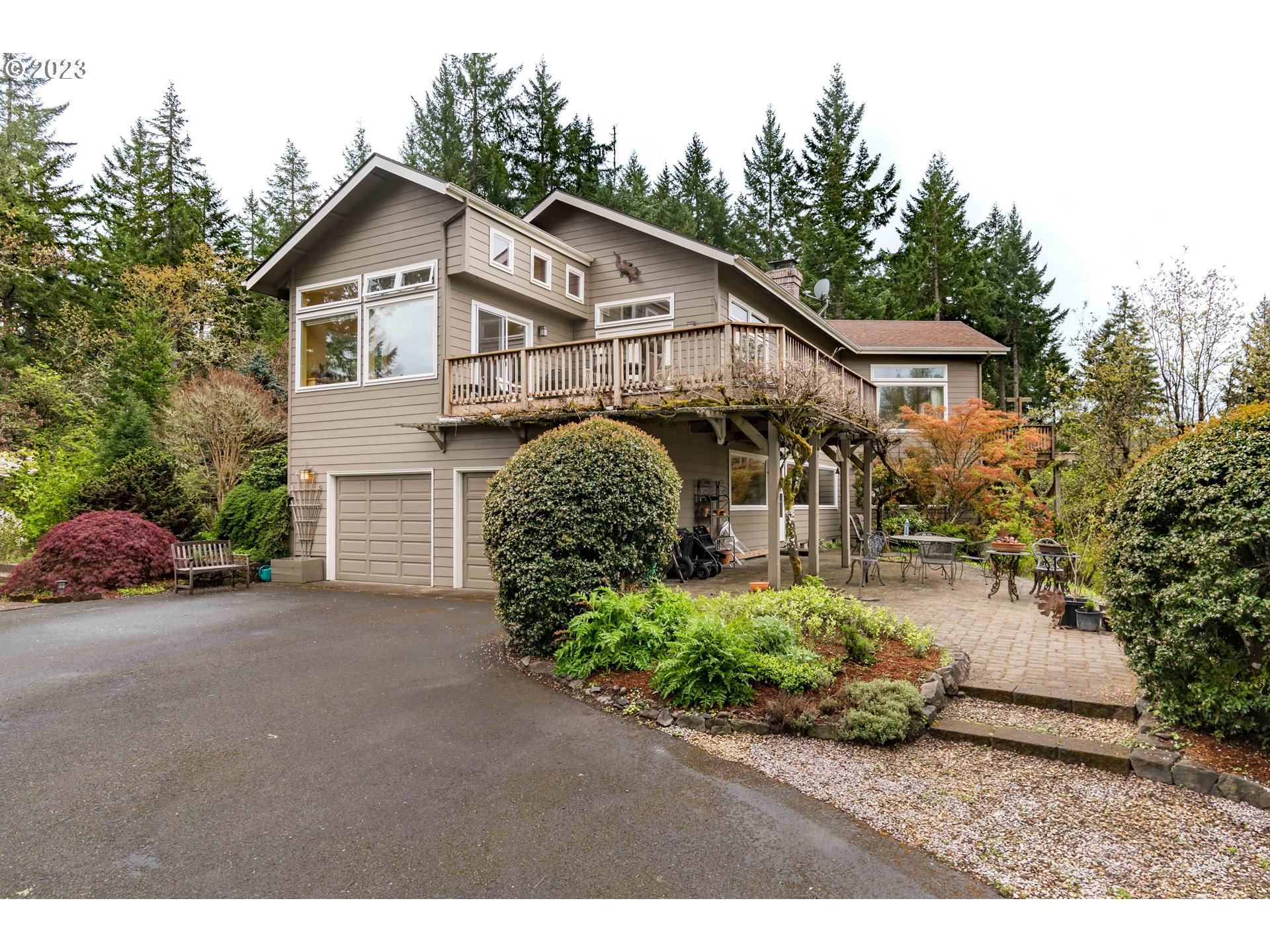 a front view of a house with a garden and plants