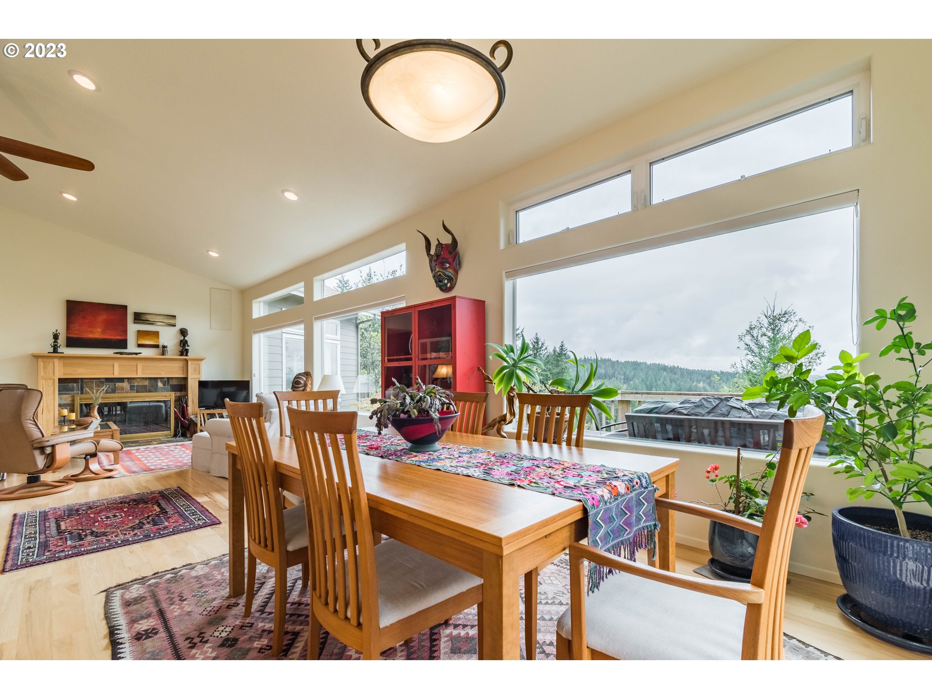84984 Appletree Drive Eugene, OR 97405 - Photo 12 of 48 a living room with furniture a potted plant and a large window