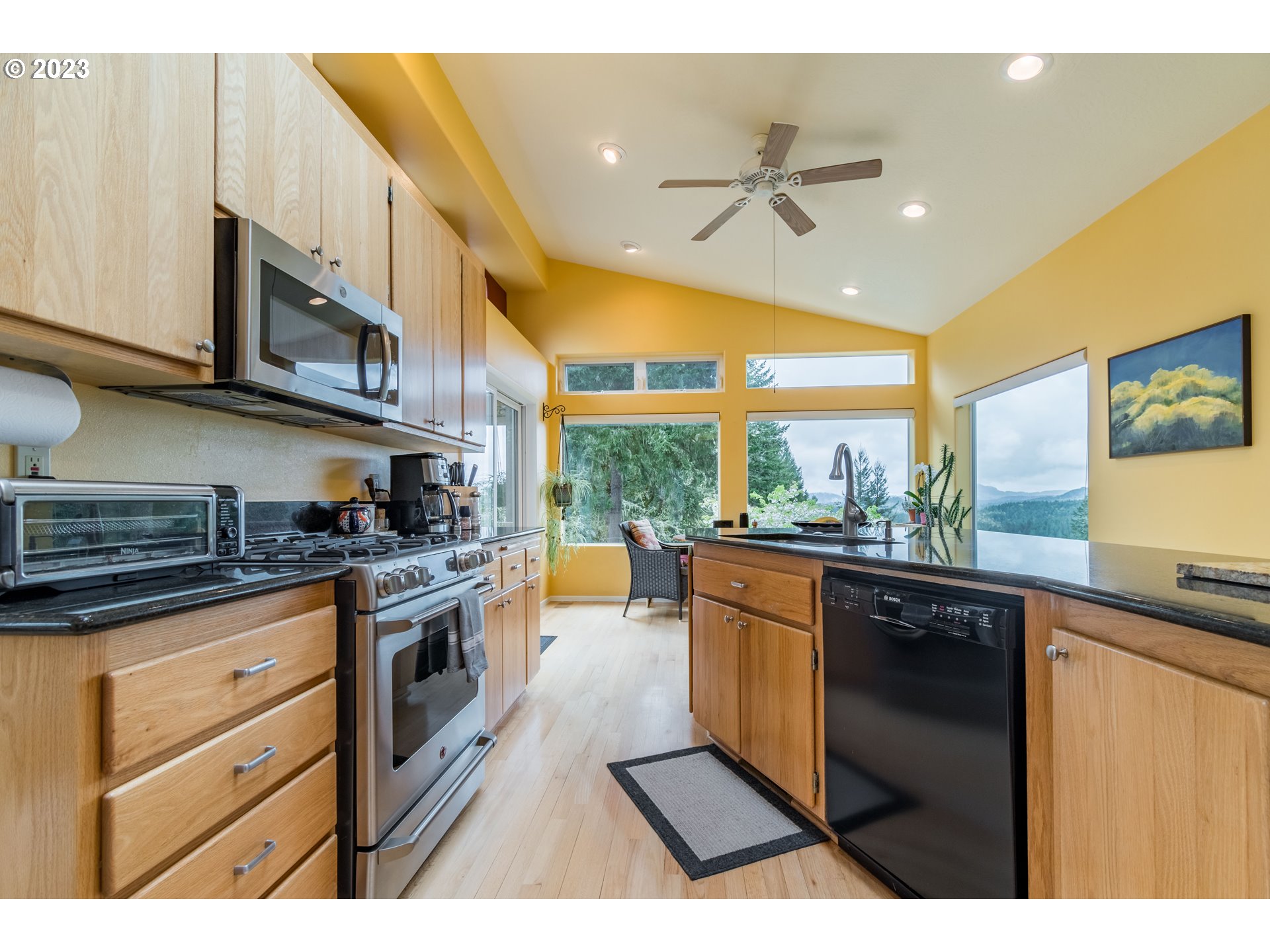 84984 Appletree Drive Eugene, OR 97405 - Photo 15 of 48 a kitchen with stainless steel appliances granite countertop a stove a sink and a microwave