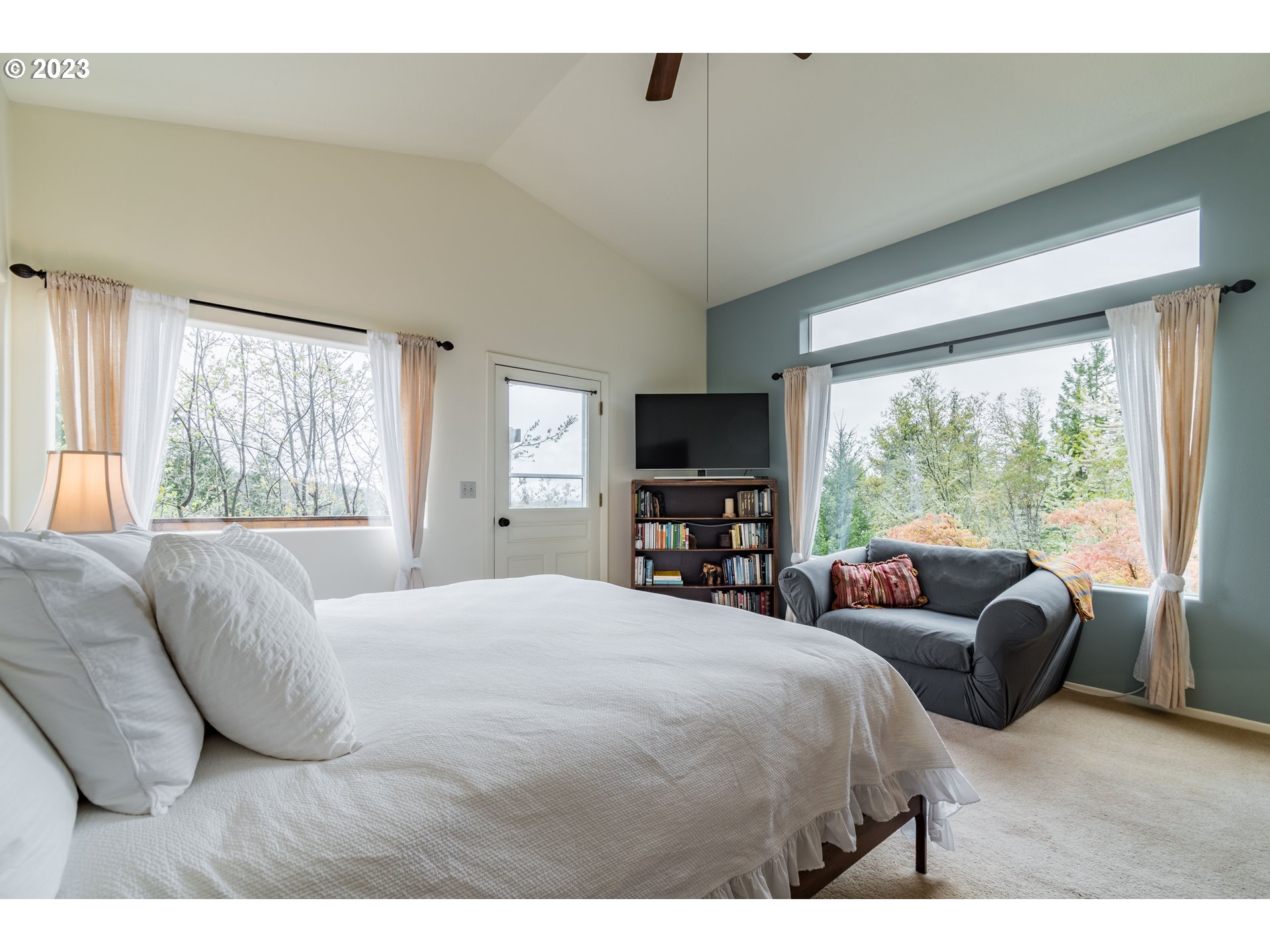 84984 Appletree Drive Eugene, OR 97405 - Photo 29 of 48 a bedroom with a bed and large windows