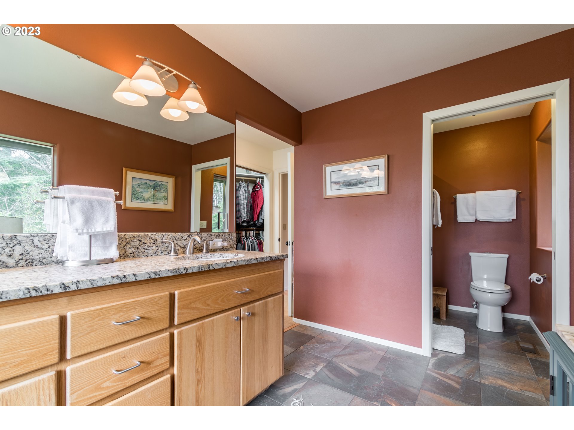 84984 Appletree Drive Eugene, OR 97405 - Photo 34 of 48 a bathroom with a granite countertop sink a toilet and a mirror