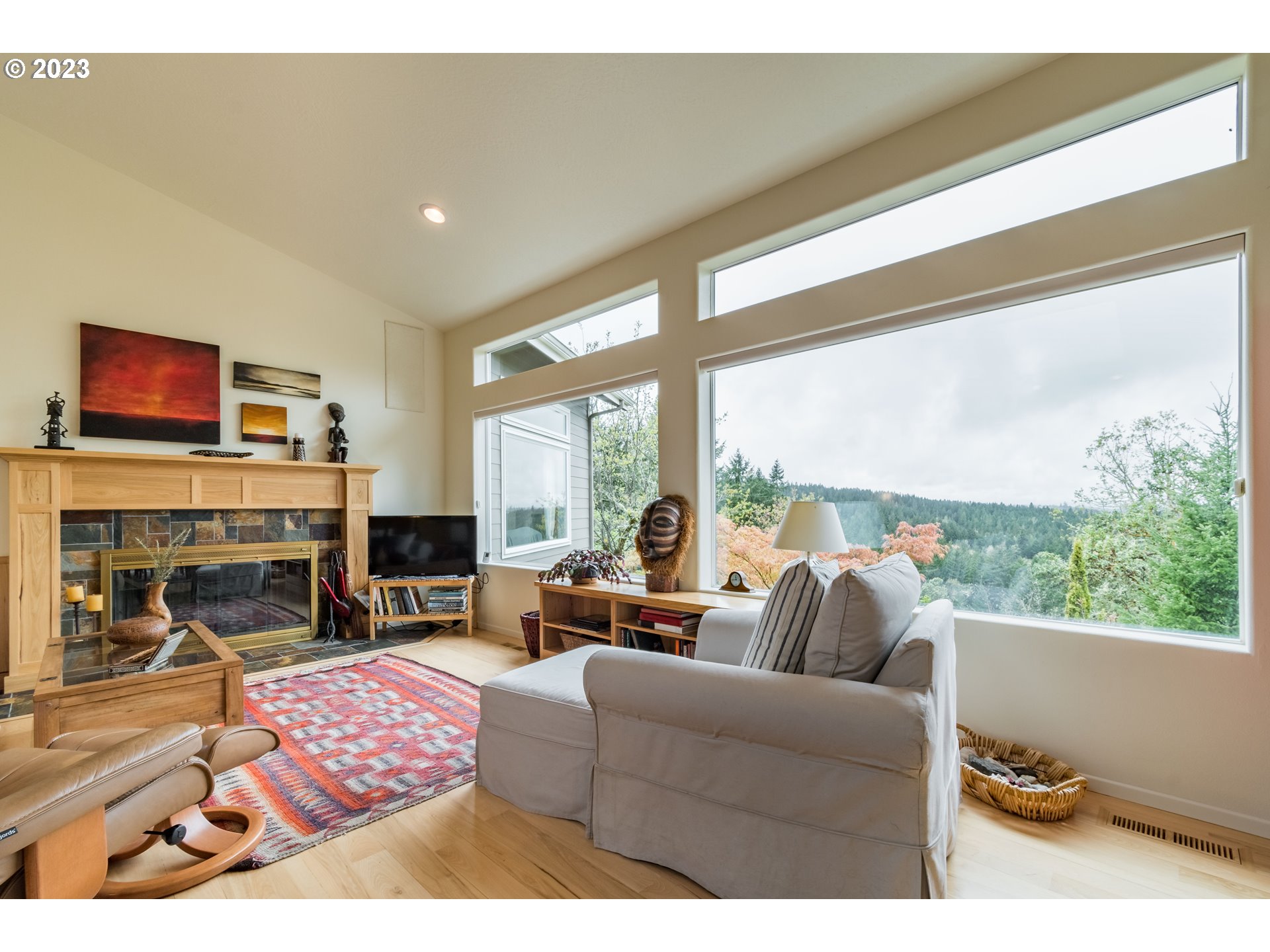 84984 Appletree Drive Eugene, OR 97405 - Photo 6 of 48 a living room with furniture a fireplace and floor to ceiling windows