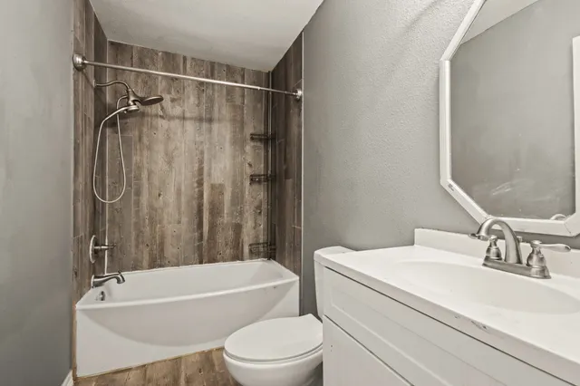 a bathroom with a sink toilet and shower