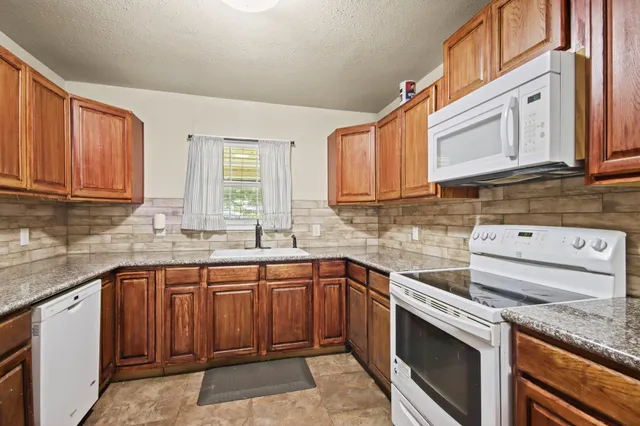 a kitchen with a sink stove and cabinets