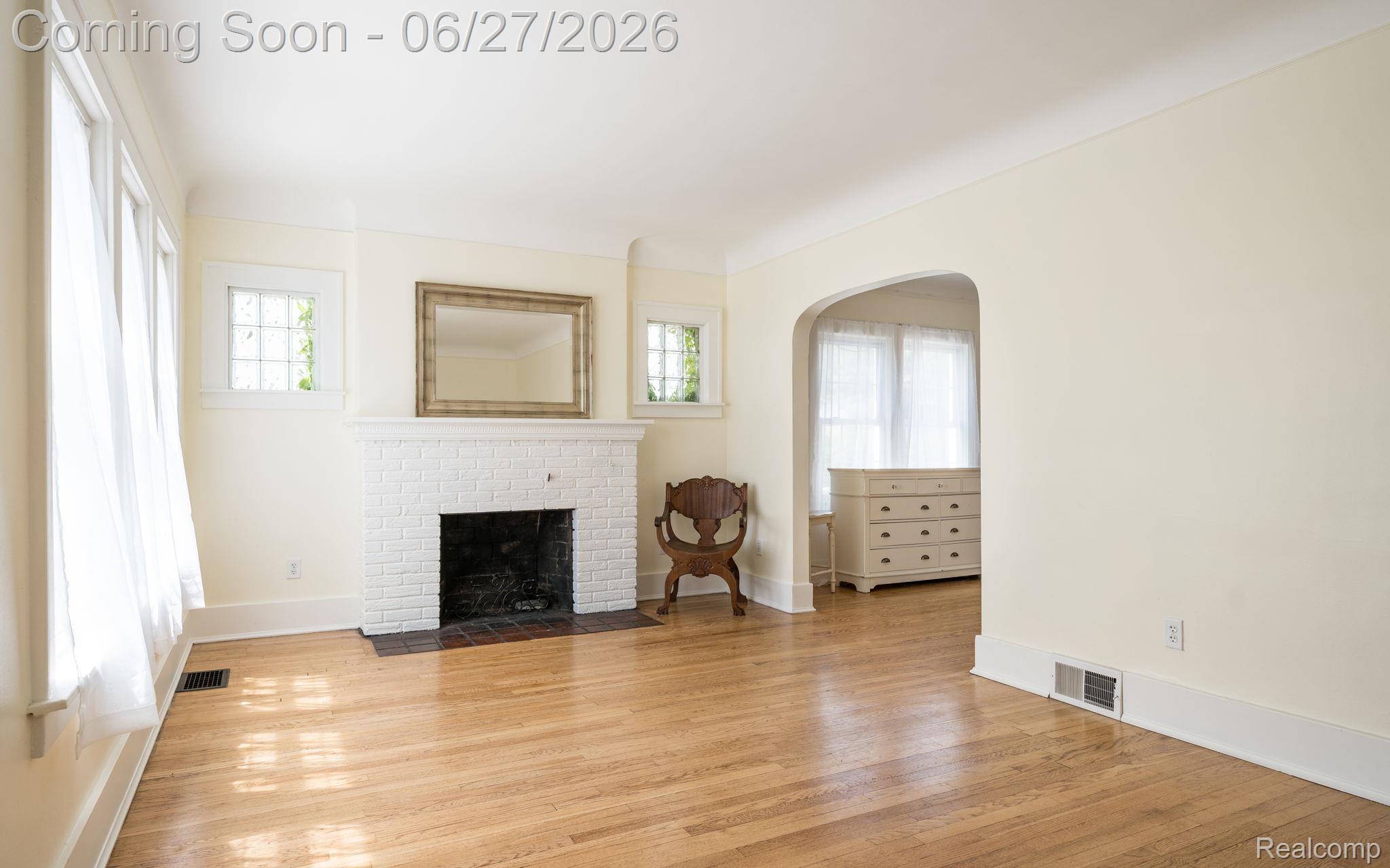 39 Mohawk Road Pontiac, MI 48341 - Photo 3 of 32 Living space featuring wood-finish flooring and a white brick fireplace