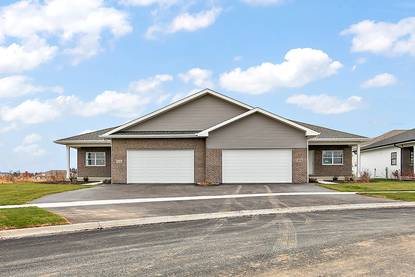 a front view of house with yard and trees around