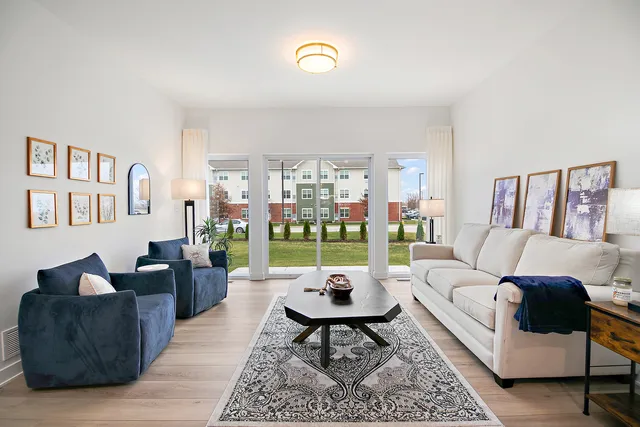 a living room with furniture and a floor to ceiling window