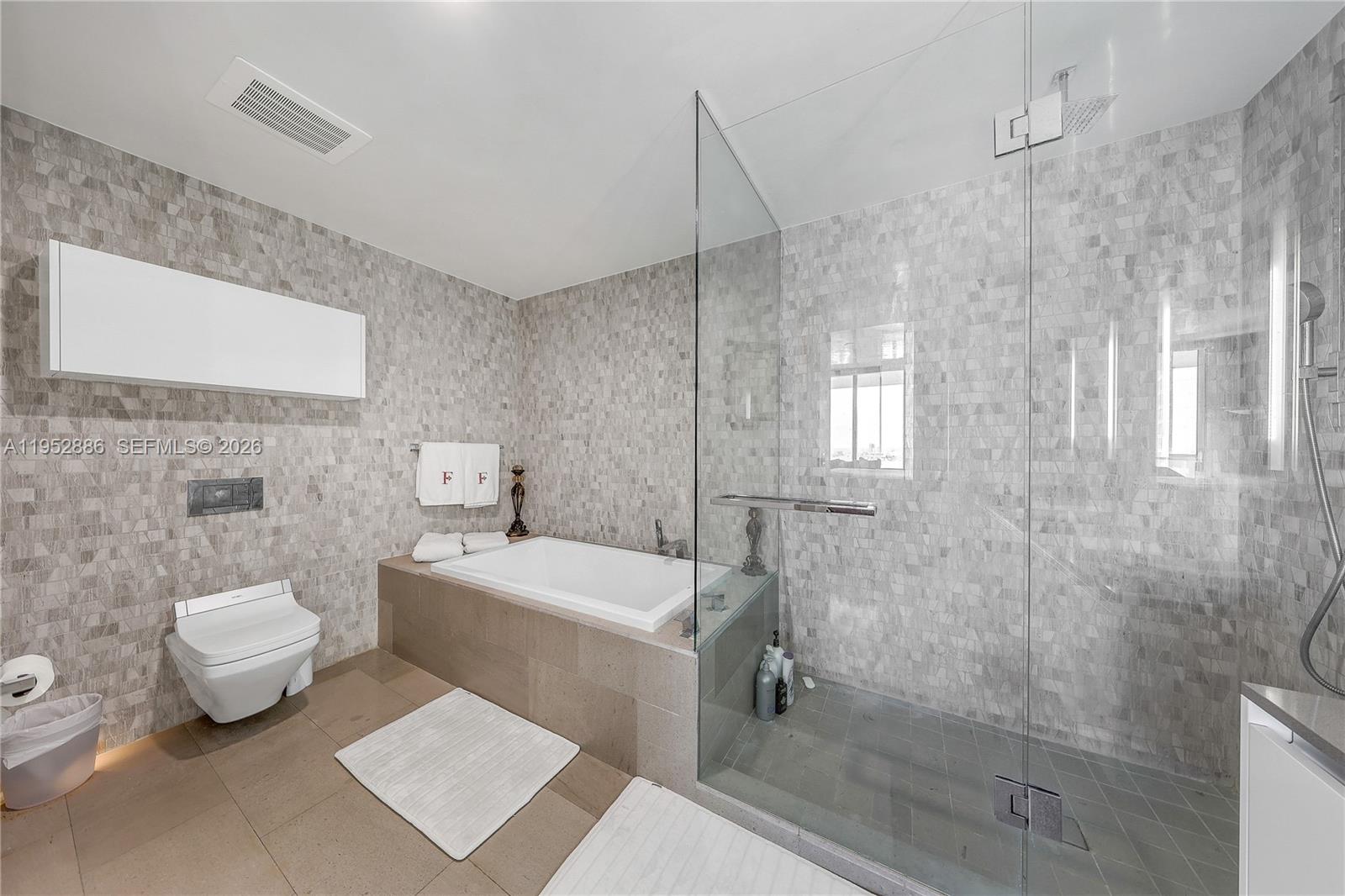 68 Southeast 6th Street, Unit 3309 Miami, FL 33131 - Photo 11 of 25 a bathroom with a sink toilet and shower