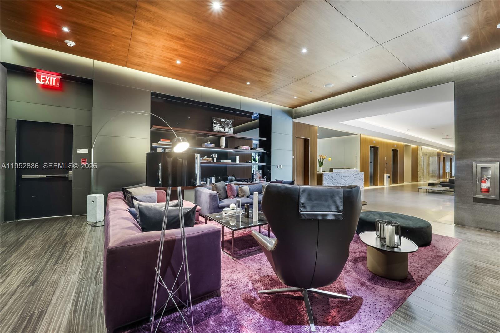 68 Southeast 6th Street, Unit 3309 Miami, FL 33131 - Photo 23 of 25 a living room with furniture a flat screen tv and kitchen view