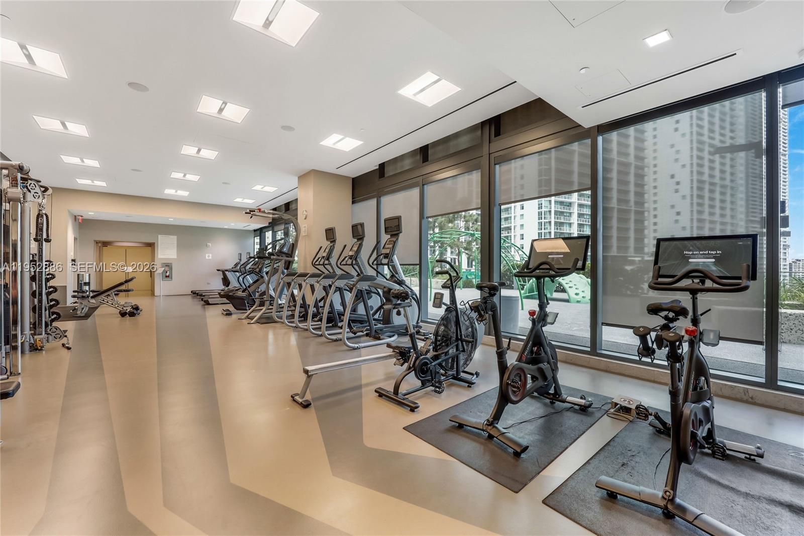68 Southeast 6th Street, Unit 3309 Miami, FL 33131 - Photo 24 of 25 a view of a room with gym equipment