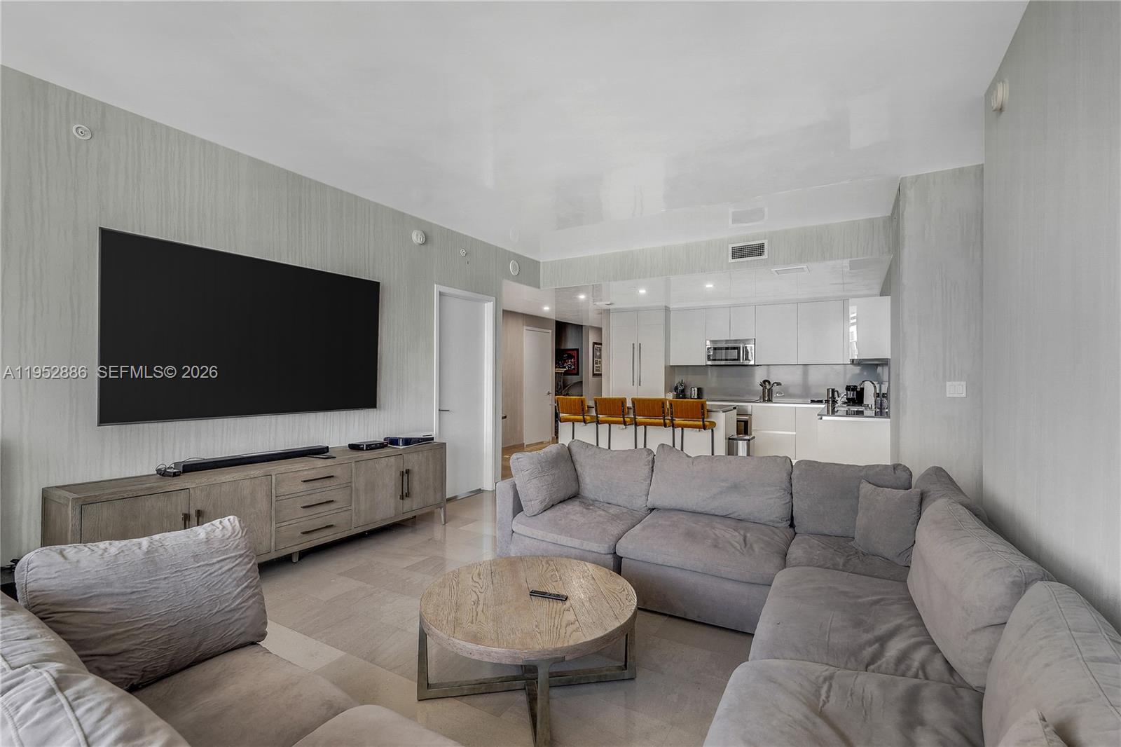 68 Southeast 6th Street, Unit 3309 Miami, FL 33131 - Photo 3 of 25 a living room with furniture and a flat screen tv