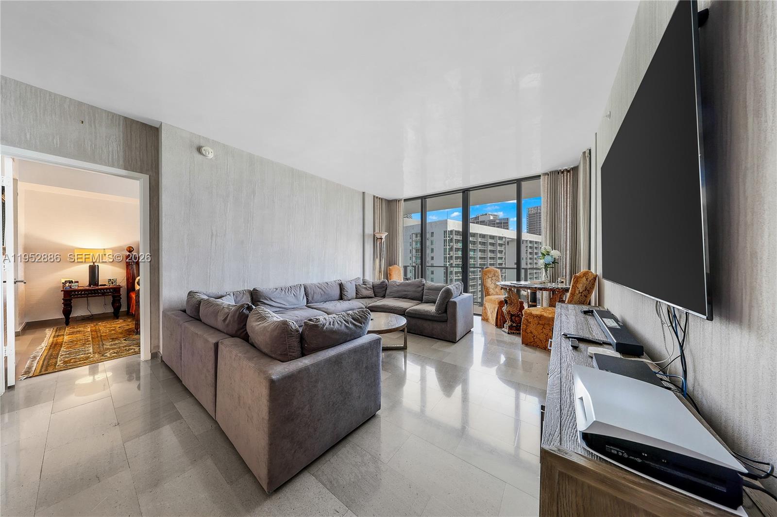 68 Southeast 6th Street, Unit 3309 Miami, FL 33131 - Photo 4 of 25 a living room with furniture and a large window