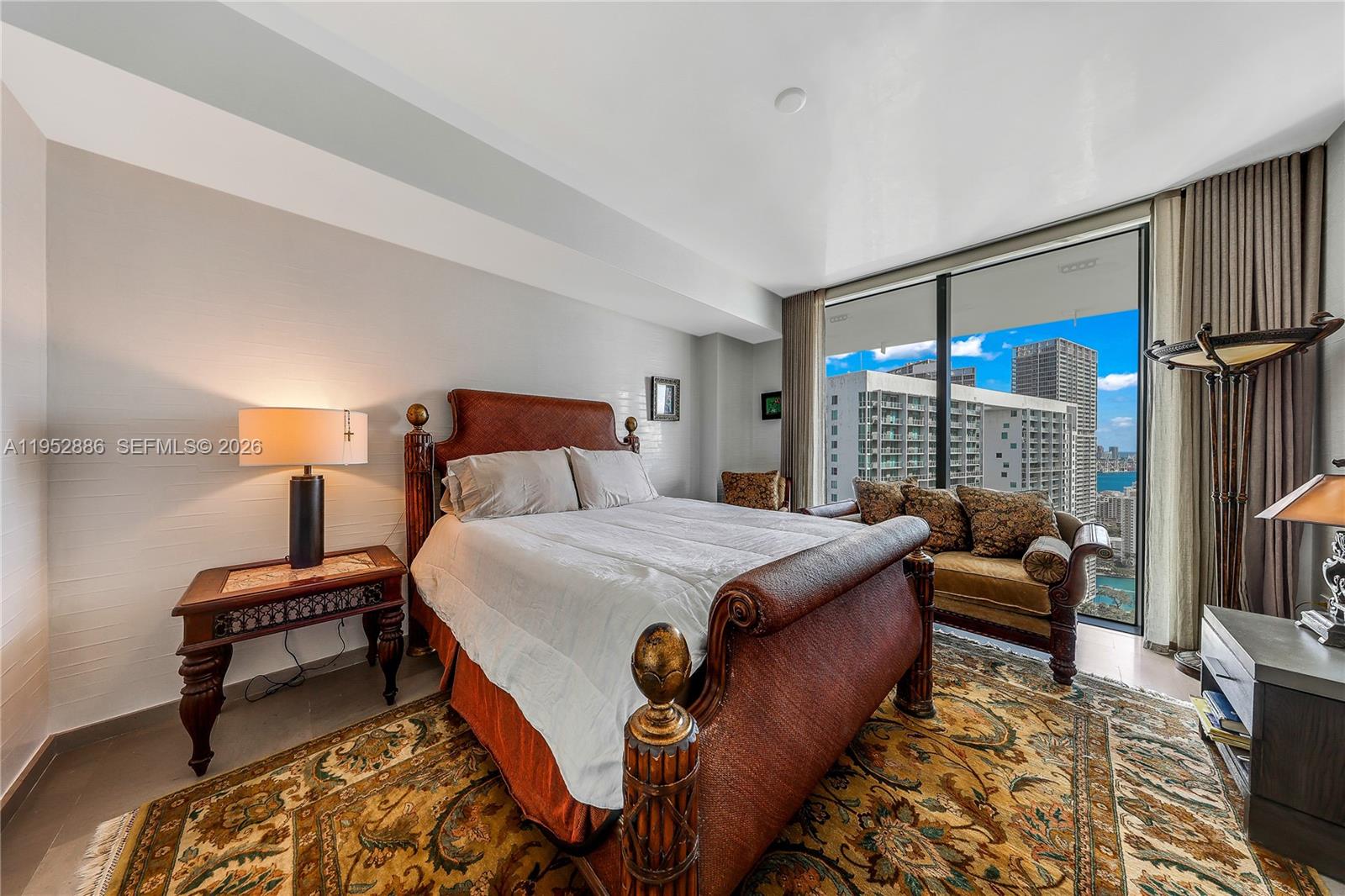 68 Southeast 6th Street, Unit 3309 Miami, FL 33131 - Photo 8 of 25 a bedroom with furniture and a large window