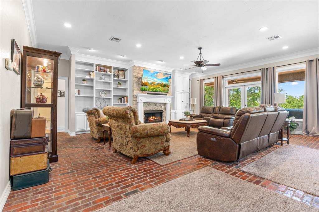 840 Winding Trail Crawford, TX 76638 - Photo 12 of 40 a living room with furniture a fireplace and a flat screen tv