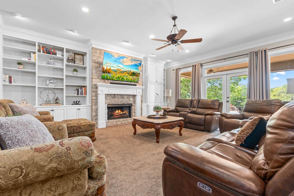 840 Winding Trail Crawford, TX 76638 - Photo 13 of 40 a living room with furniture a fireplace and a large window