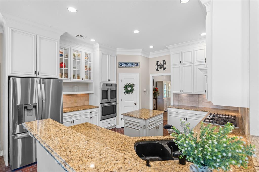 840 Winding Trail Crawford, TX 76638 - Photo 16 of 40 a living room with kitchen island furniture and a kitchen view