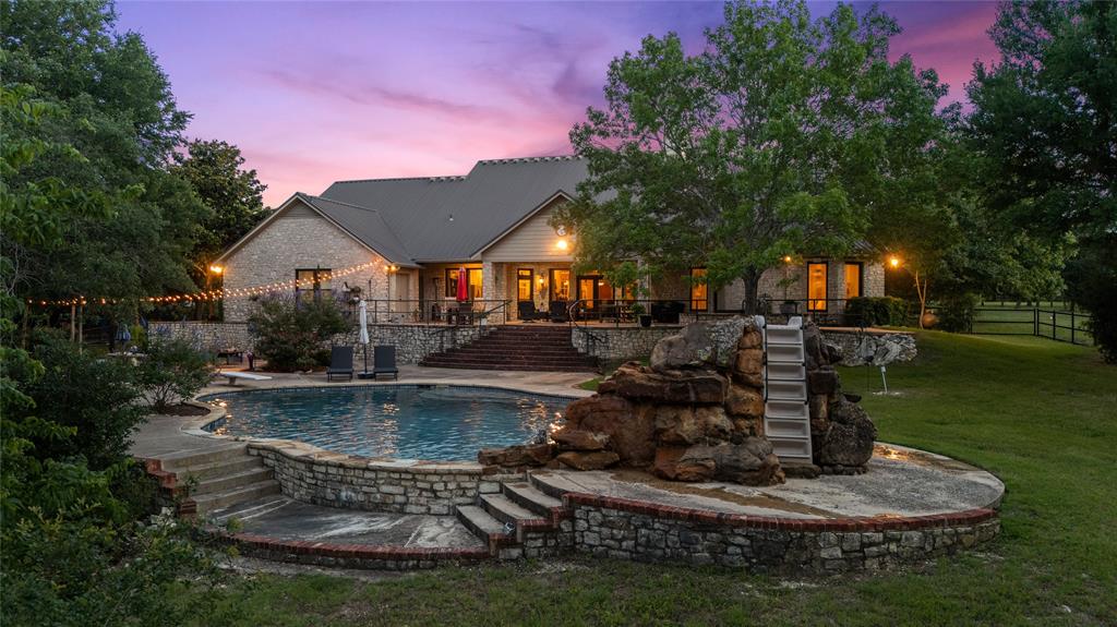 840 Winding Trail Crawford, TX 76638 - Photo 2 of 40 a view of a house with swimming pool and a yard