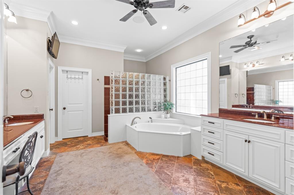 840 Winding Trail Crawford, TX 76638 - Photo 21 of 40 a spacious bathroom with a double vanity sink a mirror a bathtub and next to a window