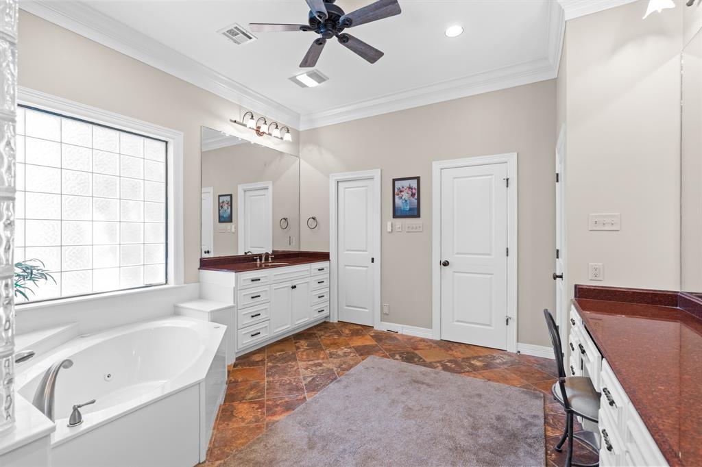 840 Winding Trail Crawford, TX 76638 - Photo 22 of 40 a bathroom with a tub sink and mirror