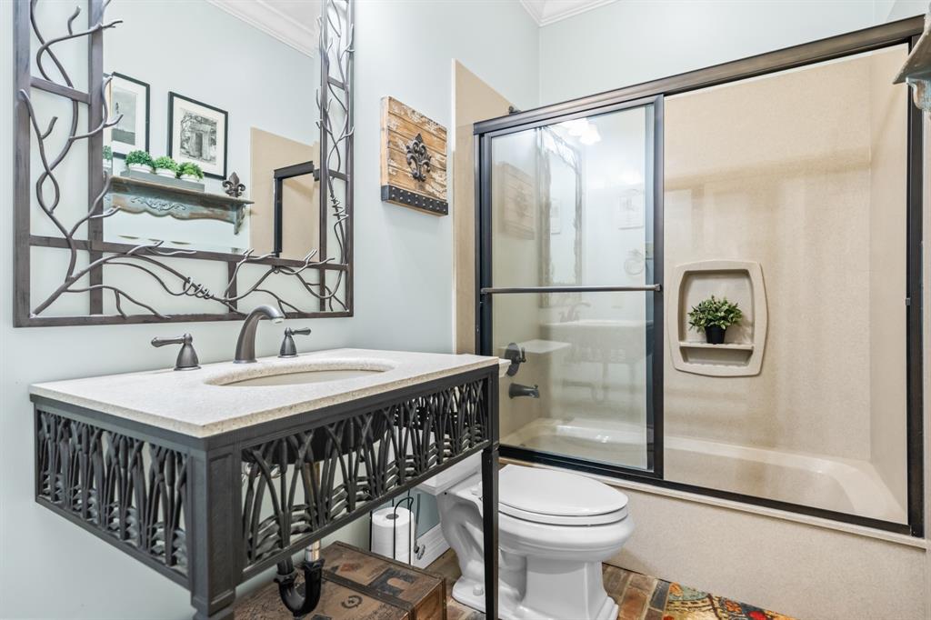 840 Winding Trail Crawford, TX 76638 - Photo 25 of 40 a bathroom with a sink a toilet a mirror and shower