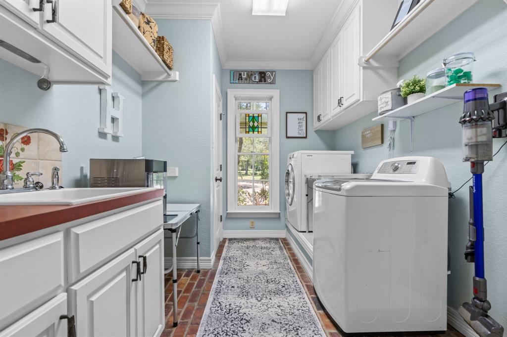 840 Winding Trail Crawford, TX 76638 - Photo 26 of 40 a utility room with cabinets washer and dryer