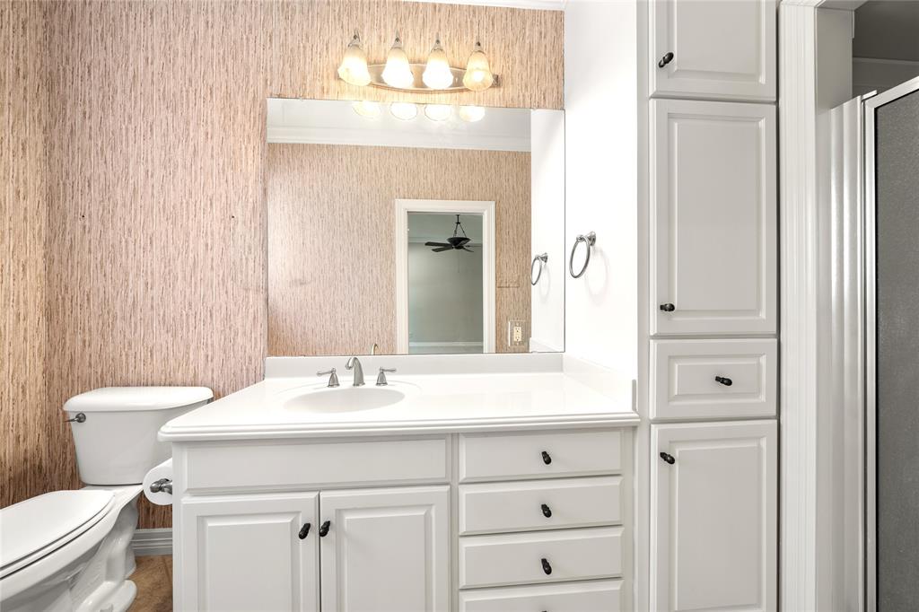 840 Winding Trail Crawford, TX 76638 - Photo 28 of 40 a bathroom with a sink vanity mirror and toilet