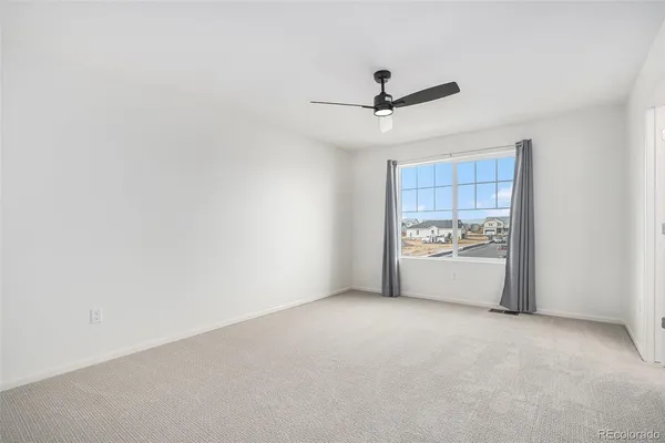 a view of a room with rack and ceiling fan