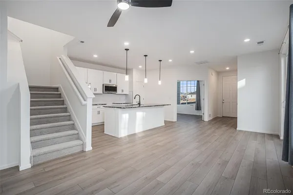 a view of kitchen with cabinets and wooden floor