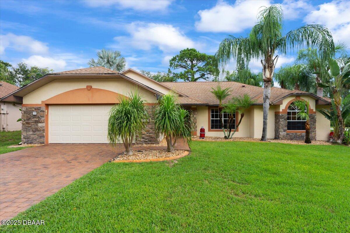 a front view of a house with a yard and garage