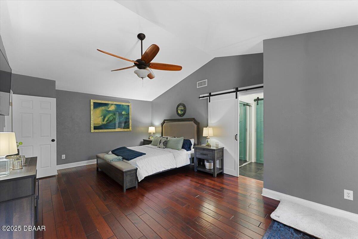 6225 Ranier Circle Port Orange, FL 32127 - Photo 18 of 50 a bedroom with a bed and wooden floor
