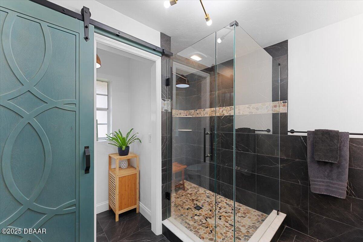 6225 Ranier Circle Port Orange, FL 32127 - Photo 21 of 50 a bathroom with a sink a toilet and shower