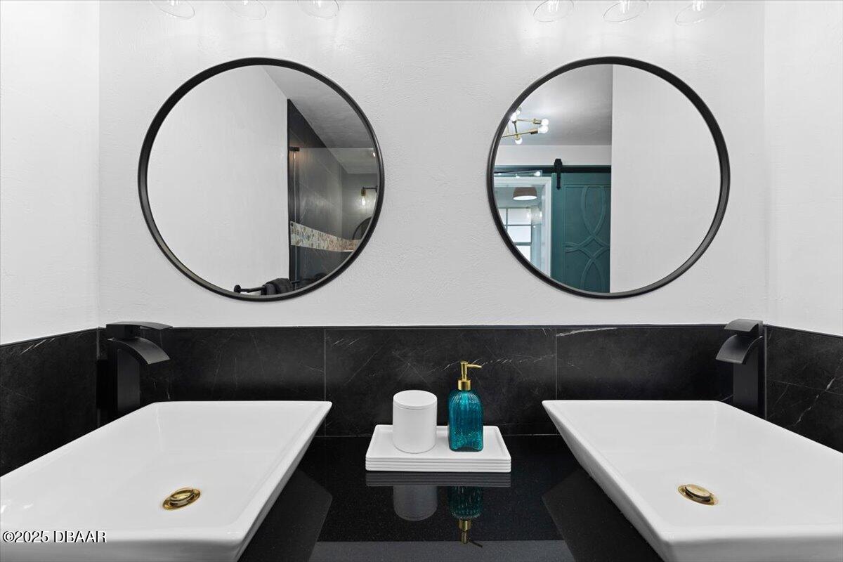 6225 Ranier Circle Port Orange, FL 32127 - Photo 24 of 50 a bathroom with a sink a mirror and bathtub