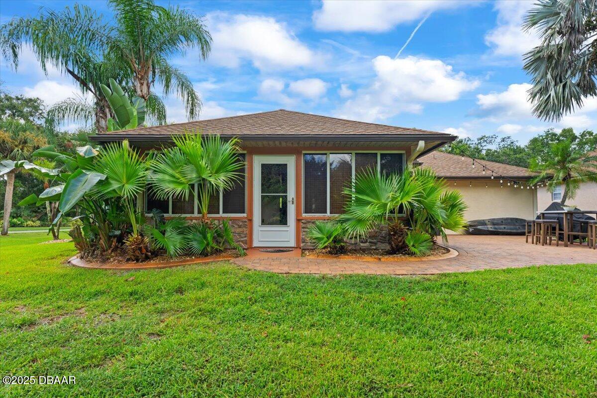6225 Ranier Circle Port Orange, FL 32127 - Photo 30 of 50 a front view of a house with a yard and porch