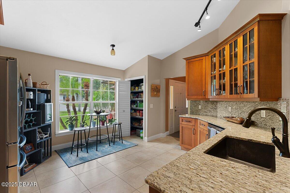 6225 Ranier Circle Port Orange, FL 32127 - Photo 8 of 50 a kitchen with a sink and a refrigerator