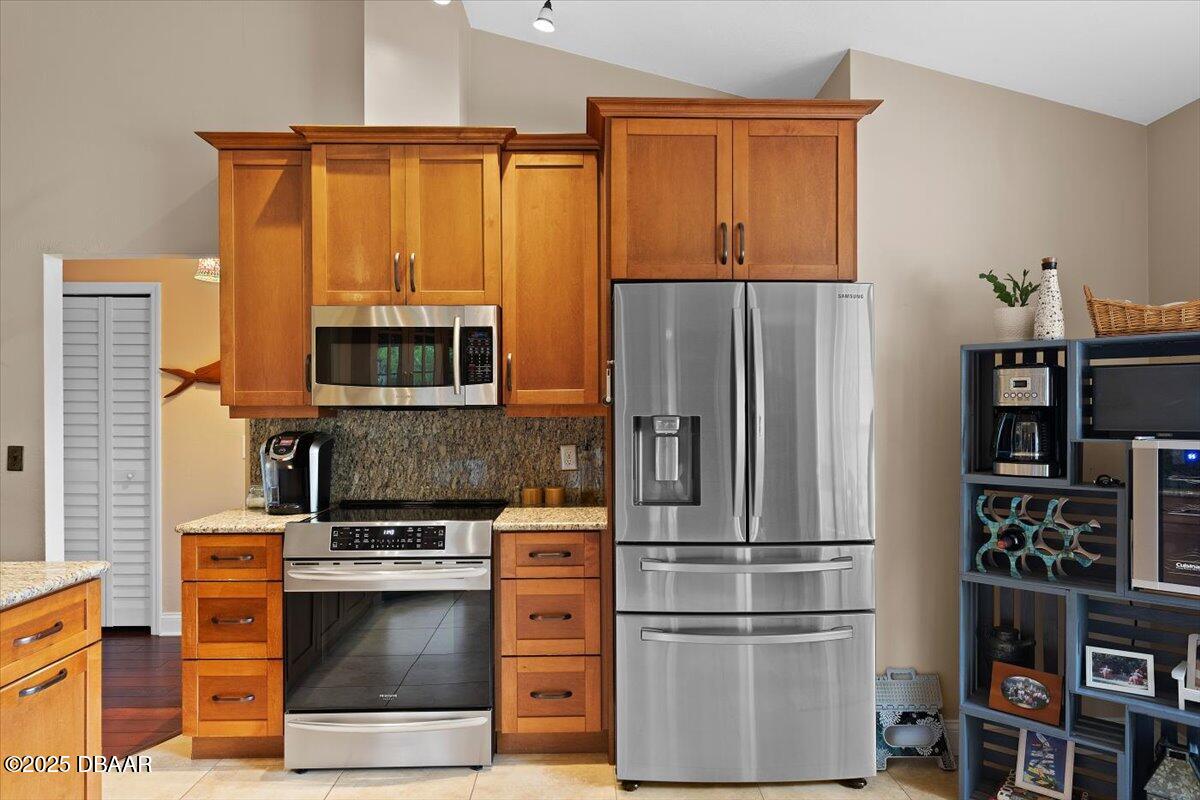 6225 Ranier Circle Port Orange, FL 32127 - Photo 9 of 50 a kitchen with stainless steel appliances and refrigerator
