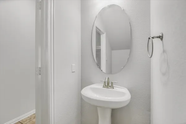 a bathroom with a sink a mirror and vanity