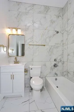 a bathroom with a sink a toilet and a bathtub