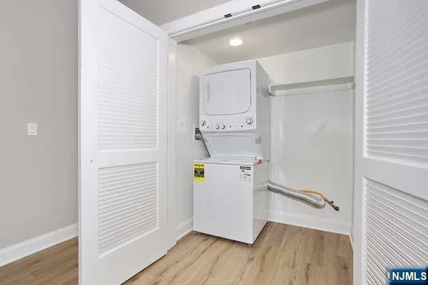 a view of storage and utility room with wooden floor