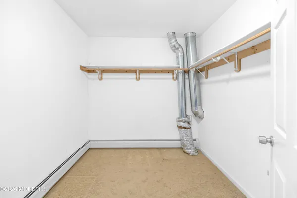a view of an empty room with a window and a ceiling fan