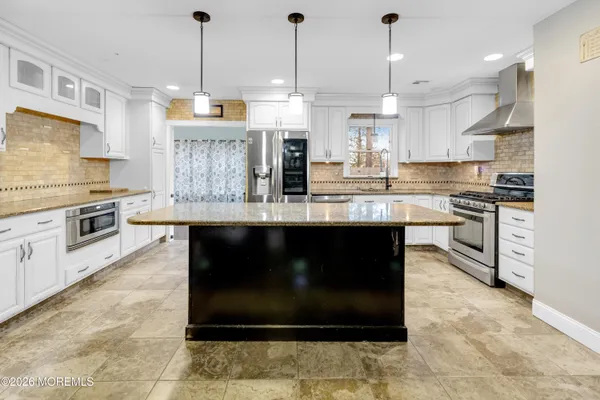a kitchen with stainless steel appliances granite countertop a stove and a refrigerator