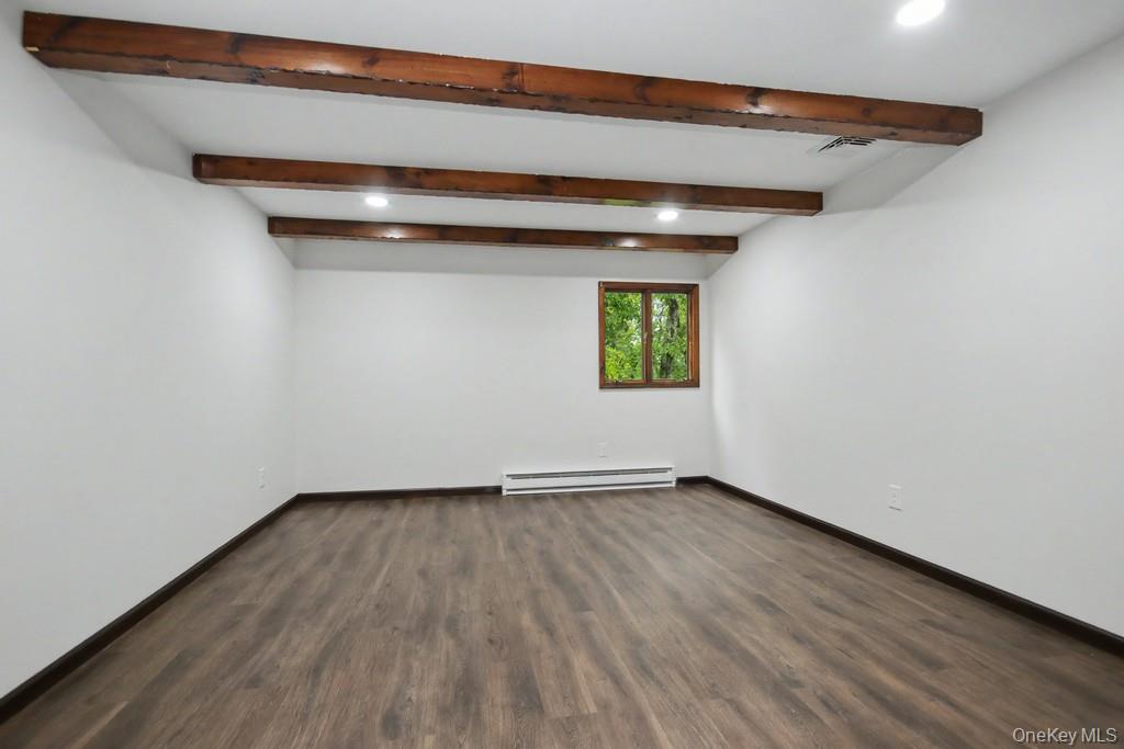 18 Hillside View Road Mahopac, NY 10541 - Photo 33 of 42 a view of an empty room with a window and wooden floor