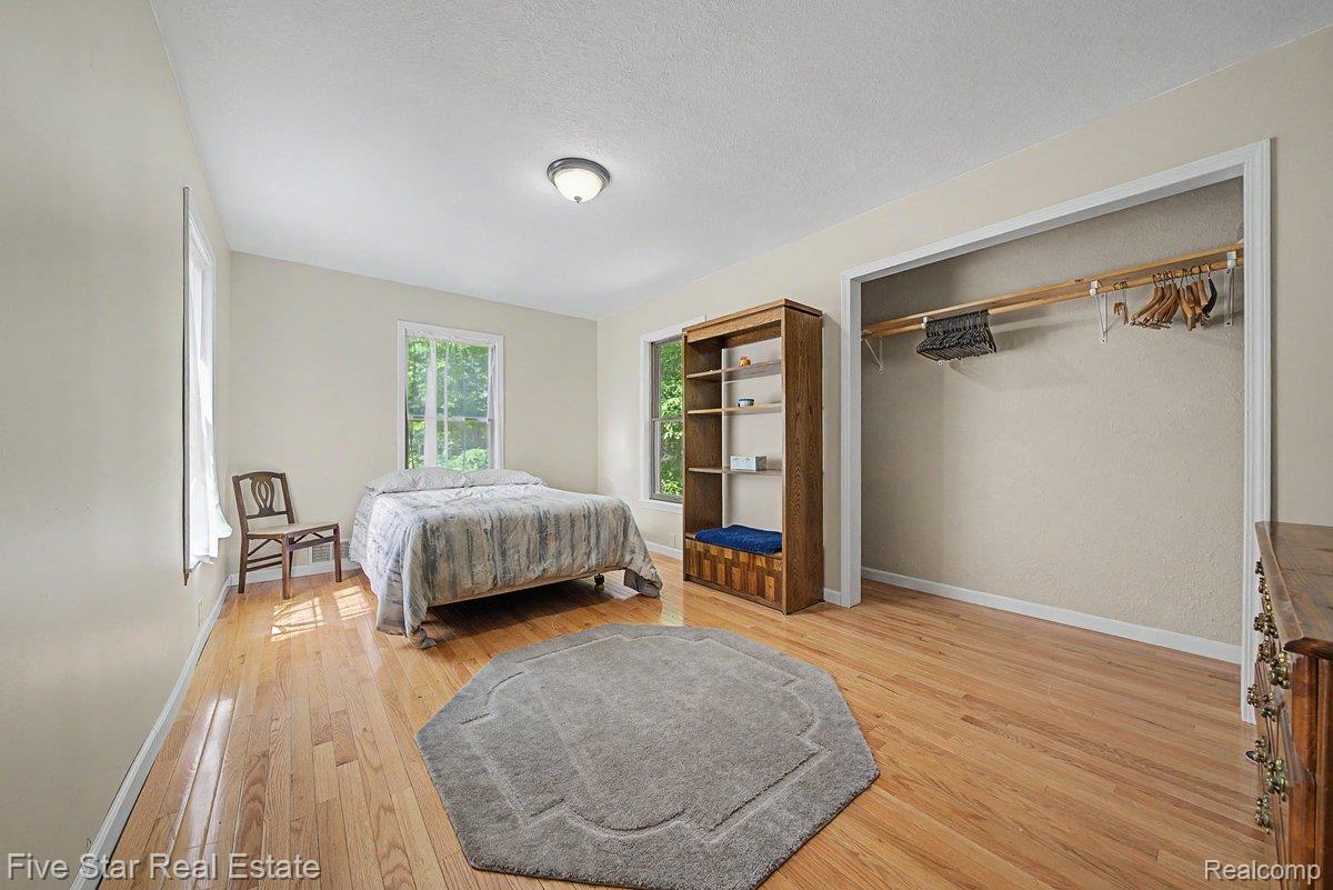 175 Bishop Road Sterling, MI 48659 - Photo 28 of 41 Hardwood-finish flooring, light-toned walls, and multiple windows