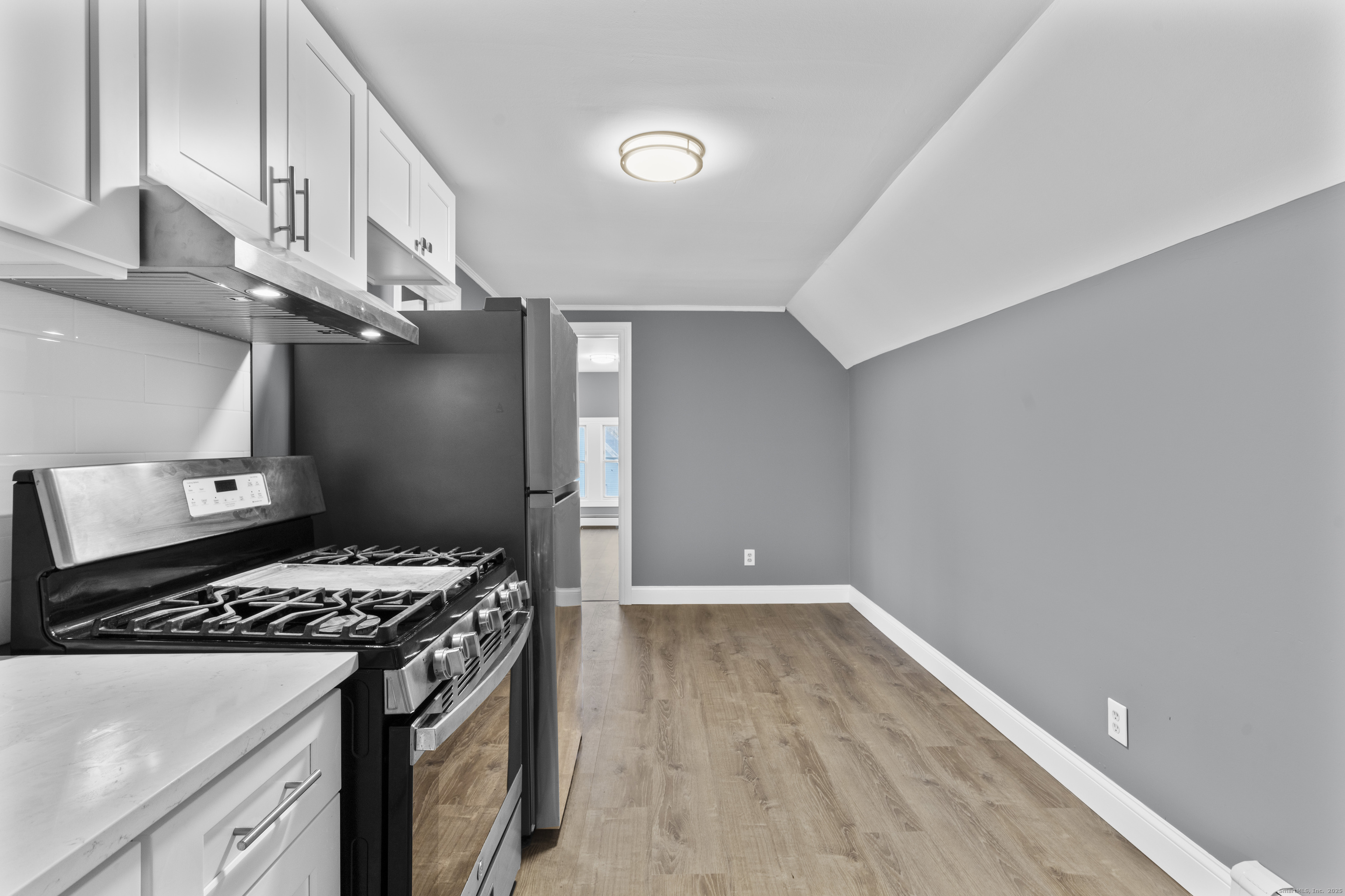 55 Elliott Street, Unit 3 New Haven, CT 06519 - Photo 11 of 18 a kitchen with a stove and a wooden floor