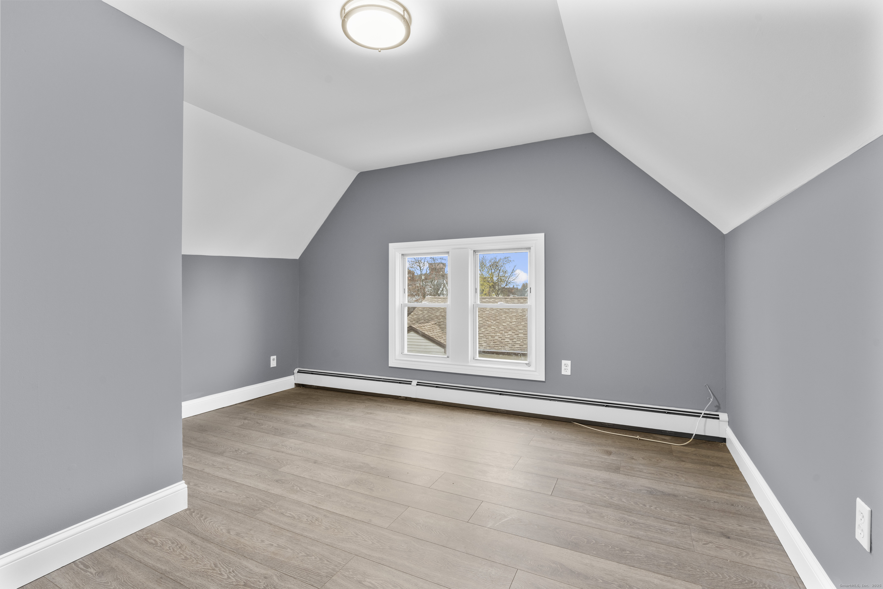 55 Elliott Street, Unit 3 New Haven, CT 06519 - Photo 6 of 18 an empty room with wooden floor and windows