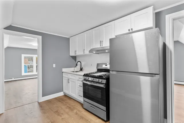 a white refrigerator freezer and a stove in a kitchen