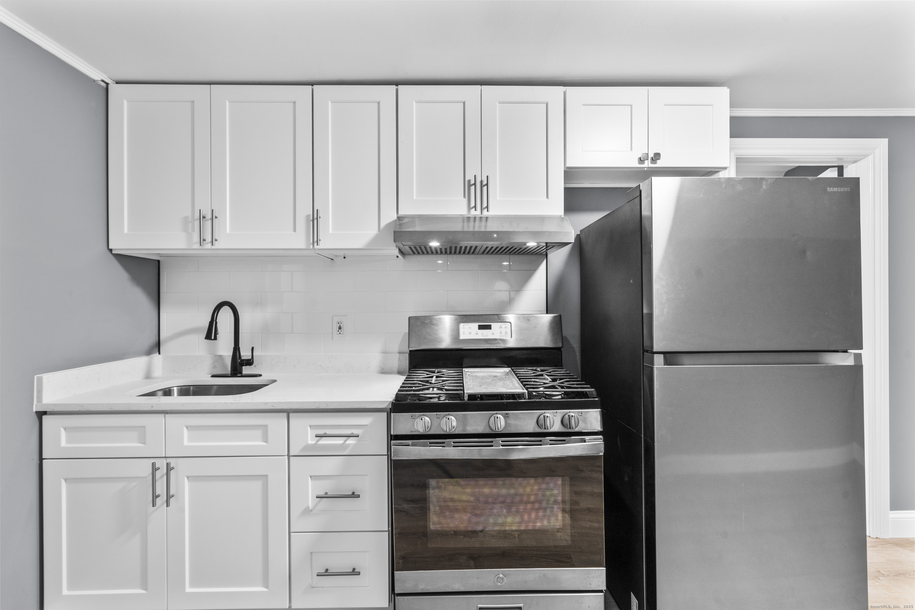 55 Elliott Street, Unit 3 New Haven, CT 06519 - Photo 10 of 18 a kitchen with refrigerator a stove a sink and cabinets