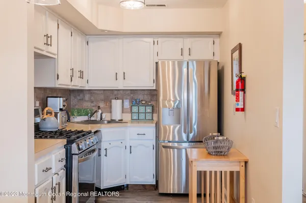 a kitchen with stainless steel appliances a refrigerator and a stove