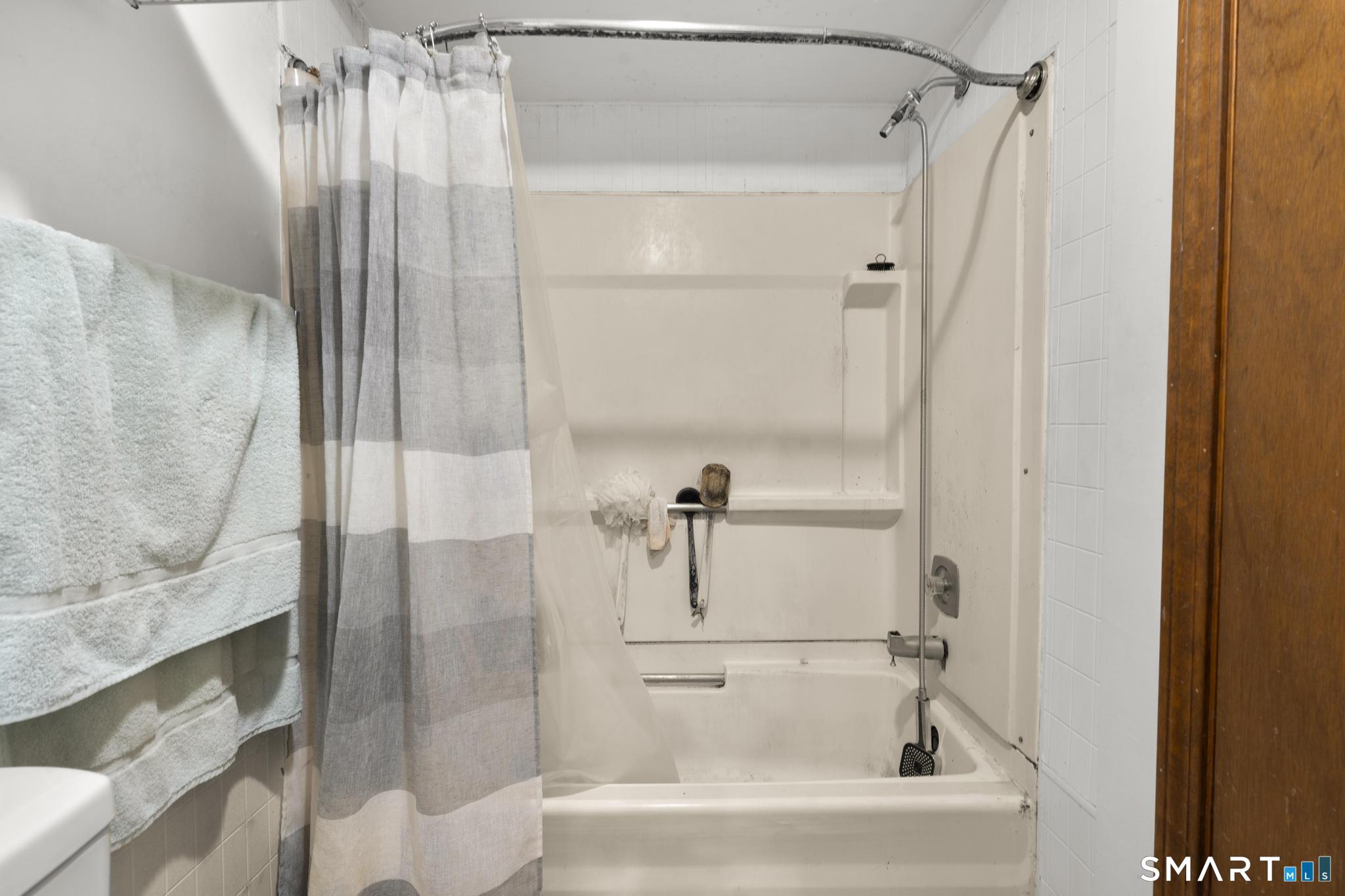 23 North First Street Meriden, CT 06451 - Photo 11 of 29 a bathroom with a bathtub and a shower